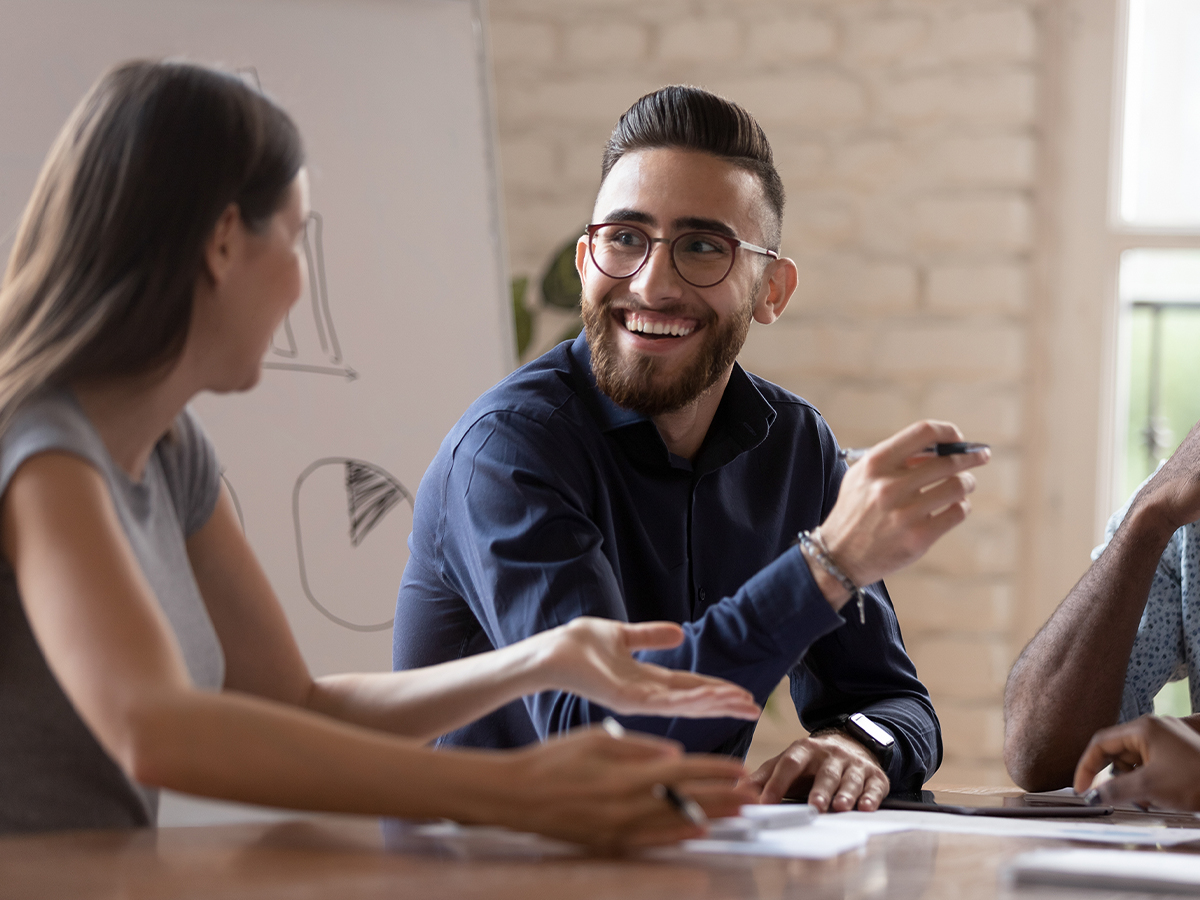 diverse group of coworkers sitting at conference room table